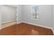 Bright bedroom featuring hardwood floors and natural light from the large window at 12286 Regal Lily Ln, Orlando, FL 32827