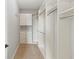 Walk-in closet with white shelving, drawers, and hanging rods at 12286 Regal Lily Ln, Orlando, FL 32827