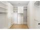 Walk-in closet with white shelving, drawers, and hanging rods at 12286 Regal Lily Ln, Orlando, FL 32827