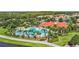 Gorgeous community pool with plenty of lounge chairs surrounded by palm trees and lush landscaping at 12286 Regal Lily Ln, Orlando, FL 32827