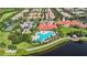 Aerial view of a community pool area with ample seating and lush landscaping in a vibrant community at 12286 Regal Lily Ln, Orlando, FL 32827