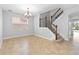 Cozy dining area with tile flooring, chandelier lighting, and a staircase leading to the upper level at 12286 Regal Lily Ln, Orlando, FL 32827