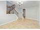Bright entryway features staircase with decorative iron railing and beautiful tiled floors at 12286 Regal Lily Ln, Orlando, FL 32827