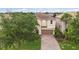 Two-story home featuring a brick driveway, neutral paint, and a well-manicured lawn at 12286 Regal Lily Ln, Orlando, FL 32827