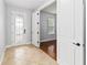 Light-filled foyer featuring tile flooring, decorative glass door, and access to other living areas at 12286 Regal Lily Ln, Orlando, FL 32827