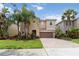 Charming two-story home with a brick driveway, well-manicured lawn and beautiful landscaping at 12286 Regal Lily Ln, Orlando, FL 32827