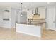 Bright kitchen island with granite countertops, pendant lighting, and stainless steel appliances at 12286 Regal Lily Ln, Orlando, FL 32827