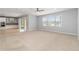 Spacious living room featuring neutral carpet, recessed lighting and a large window with backyard view at 12286 Regal Lily Ln, Orlando, FL 32827