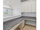 Office space with built-in desk, granite countertop, and overhead cabinets at 12286 Regal Lily Ln, Orlando, FL 32827