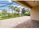 Screened-in patio offers a brick floor and scenic views of the backyard and lake at 12286 Regal Lily Ln, Orlando, FL 32827