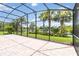 Spacious screened-in patio with a brick floor and a serene view of lush landscaping and a peaceful lake at 12286 Regal Lily Ln, Orlando, FL 32827