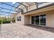Rear exterior of home features large screened-in patio with brick flooring that is perfect for entertaining at 12286 Regal Lily Ln, Orlando, FL 32827