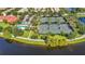 Aerial view of community tennis courts with lush landscaping, pool, and clubhouse at 12286 Regal Lily Ln, Orlando, FL 32827