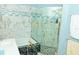 The bathroom features marble accent walls, modern tile work, and glass shower doors at 12406 Beacontree Way, Orlando, FL 32837