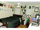 Bedroom with a dark wood floor, dark furniture, ceiling fan and decorated green walls at 12406 Beacontree Way, Orlando, FL 32837
