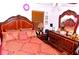 Bedroom featuring a decorative headboard, dresser and side table with wood floors at 12406 Beacontree Way, Orlando, FL 32837