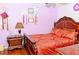 Cozy bedroom with a decorative headboard, side table, luxury bedding and wood floors at 12406 Beacontree Way, Orlando, FL 32837