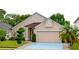 Charming single-Gathering home featuring manicured lawn and a two-car garage at 12406 Beacontree Way, Orlando, FL 32837