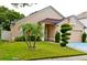 Charming one-story home with landscaped yard and a two-car garage at 12406 Beacontree Way, Orlando, FL 32837