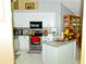 Modern kitchen featuring white cabinetry, stainless steel appliances, and granite countertops at 12406 Beacontree Way, Orlando, FL 32837
