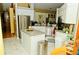 Spacious kitchen with stainless steel appliances, a center island, and marble tile flooring at 12406 Beacontree Way, Orlando, FL 32837