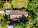 Top-down aerial view of a house with a large roof and lush surrounding trees at 1250 Tangerine Ct, Eustis, FL 32726