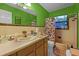 Vintage bathroom featuring single vanity, toilet, bathtub, and colorful accents at 1250 Tangerine Ct, Eustis, FL 32726