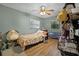Bedroom with wood flooring, window, and a ceiling fan at 1250 Tangerine Ct, Eustis, FL 32726