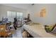 Bedroom with a bed and desk area, alongside a window at 1250 Tangerine Ct, Eustis, FL 32726