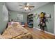 Bedroom with ceiling fan, wood flooring, and small desk at 1250 Tangerine Ct, Eustis, FL 32726