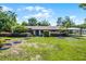 Well-maintained home with lush green lawn, covered carport, and inviting facade at 1250 Tangerine Ct, Eustis, FL 32726