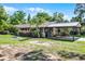 Attractive home with mature landscaping and a convenient covered carport at 1250 Tangerine Ct, Eustis, FL 32726