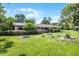 Beautiful home featuring a well-manicured lawn, covered carport, and mature landscaping at 1250 Tangerine Ct, Eustis, FL 32726