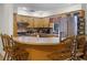 Warm kitchen featuring wooden cabinets and breakfast bar at 1250 Tangerine Ct, Eustis, FL 32726