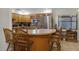 Bright eat-in kitchen with wooden cabinets, tiled backsplash, and center island with seating at 1250 Tangerine Ct, Eustis, FL 32726