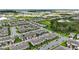 An aerial view of a new home community featuring orderly streets, landscaping, and natural wetlands at 13293 Pontoon Rd, Winter Garden, FL 34787