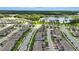An aerial view of a neighborhood featuring new construction homes, landscaping, and a tranquil lake at 13293 Pontoon Rd, Winter Garden, FL 34787