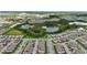An aerial view shows neighborhood with ponds, green spaces, and diverse architectural styles at 13293 Pontoon Rd, Winter Garden, FL 34787