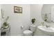 Chic powder room featuring modern fixtures, pedestal sink, and fresh neutral decor at 13293 Pontoon Rd, Winter Garden, FL 34787