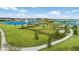 An aerial view features the community dog park, lakes, fountains, and lush green spaces at 13293 Pontoon Rd, Winter Garden, FL 34787