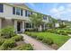 Beautiful townhome showcasing well-maintained landscaping, a brick walkway, and inviting curb appeal at 13293 Pontoon Rd, Winter Garden, FL 34787