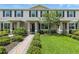 Charming townhome featuring a brick walkway, manicured lawn, and inviting entrance at 13293 Pontoon Rd, Winter Garden, FL 34787