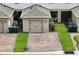 Detached townhome garages with brick driveways and lush landscaping at 13293 Pontoon Rd, Winter Garden, FL 34787