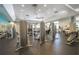 The spacious gym features a variety of weight machines, cardio equipment, and ample natural light at 13293 Pontoon Rd, Winter Garden, FL 34787