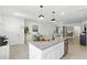 Open kitchen with a large island, granite countertops, stainless steel appliances, and bright lighting at 13293 Pontoon Rd, Winter Garden, FL 34787