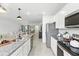 Modern kitchen with granite countertops, stainless steel appliances, and an open design leading to the living area at 13293 Pontoon Rd, Winter Garden, FL 34787