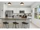 Bright kitchen featuring white cabinetry, granite countertops, stainless steel appliances, and an island at 13293 Pontoon Rd, Winter Garden, FL 34787