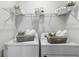 Organized laundry room with washer, dryer, wire rack, and ample storage space at 13293 Pontoon Rd, Winter Garden, FL 34787