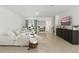 Inviting living room with comfortable seating, neutral decor, tile floors, and a mounted television at 13293 Pontoon Rd, Winter Garden, FL 34787