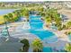 Aerial view features a resort-style pool with fountains, palm trees, and plenty of lounge seating at 13293 Pontoon Rd, Winter Garden, FL 34787